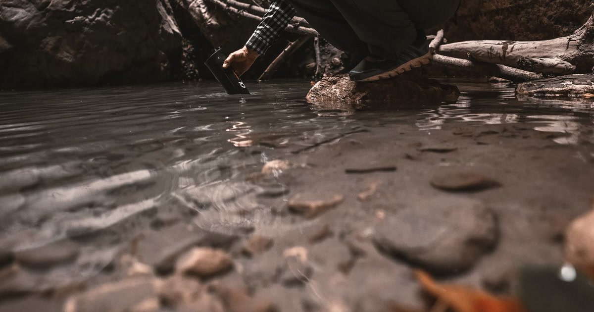 Filtering water from a wilderness stream with a portable water filter