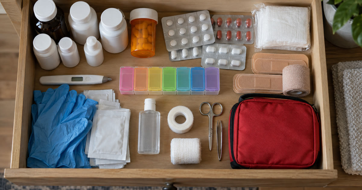 An organized home medicine kit with OTC medications and a pill organizer